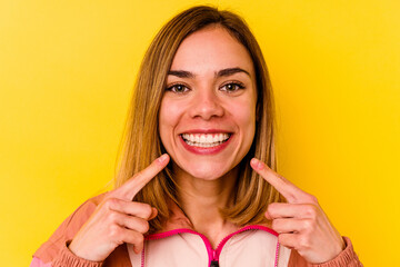 Young caucasian woman wearing invisible orthodontics isolated on yellow background