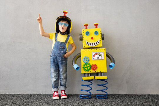 Naklejki Happy child with toy robot