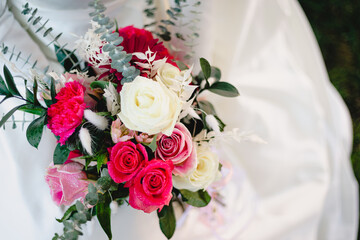 Bride holds beautiful vibrant wedding bouquet