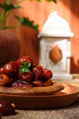 dates fruit in a wooden plate against brown background