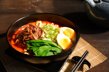 a bowl of spicy noodle with various topping or known as  ramen 