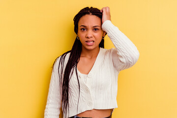 Young african american woman isolated on yellow background forgetting something, slapping forehead...