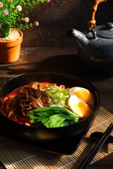 a bowl of spicy noodle with various topping or known as  ramen 