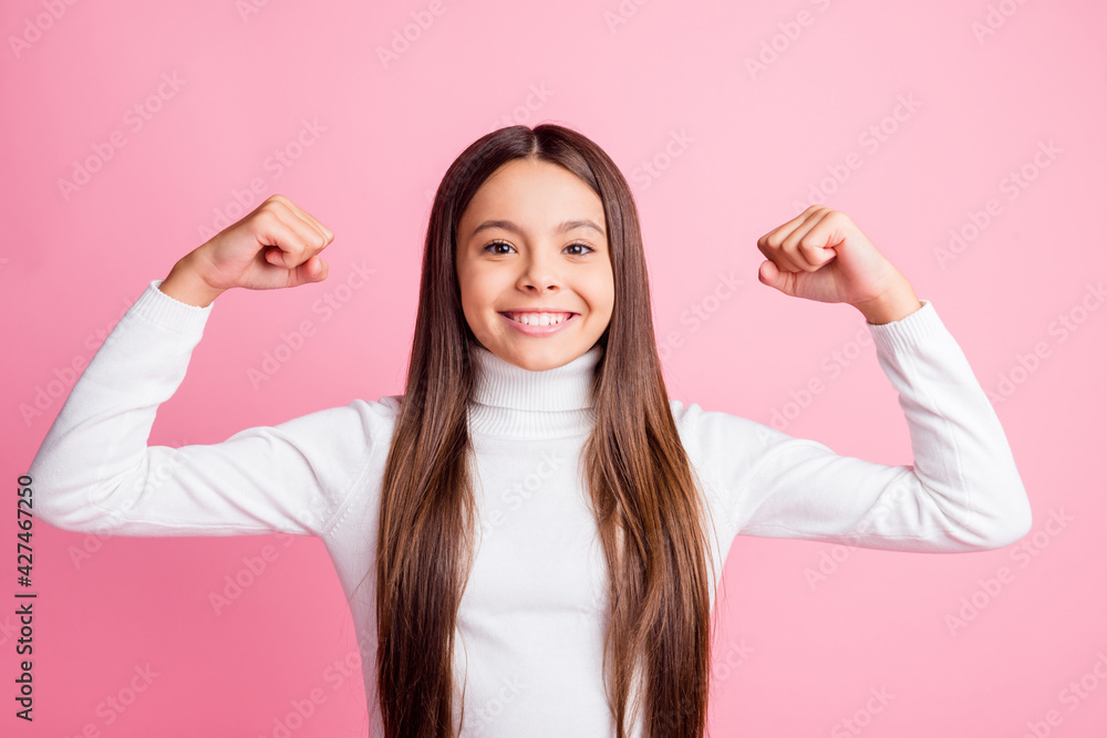 Poster Photo of satisfied school girl toothy smile hands flexing biceps look camera isolated on pink color background