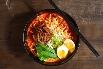 a bowl of spicy noodle with various topping or known as  ramen 