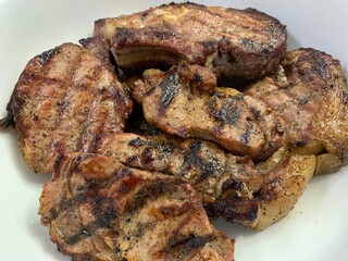 Grilled fatty meat. Marbled beef steak on a plate. Pork cuts