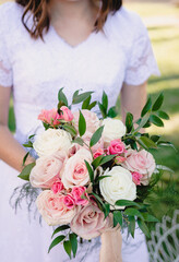 Obraz na płótnie Canvas Bride holds beautiful vibrant wedding bouquet