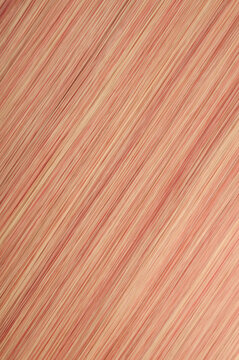 closeup texture of single piece clip in straight red mixed with blonde highlights synthetic hair extensions