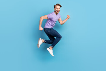 Full length body profile photo of cheerful careless man jumping high running on sale isolated on pastel blue color background