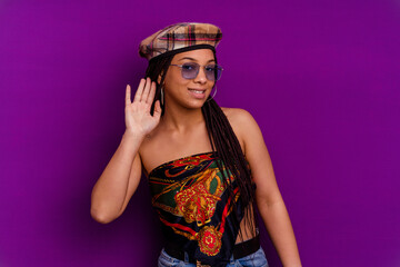 Young african american woman isolated on yellow background Young african american woman isolated on yellow background trying to listening a gossip.