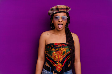 Young african american woman isolated on yellow background Young african american woman isolated on yellow background funny and friendly sticking out tongue.