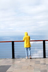 A girl in a yellow raincoat. Fethiye, district of Muğla Province in the Aegean Region of Turkey.