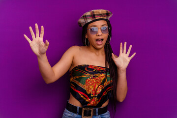 Young african american woman isolated on yellow background Young african american woman isolated on yellow background being shocked due to an imminent danger