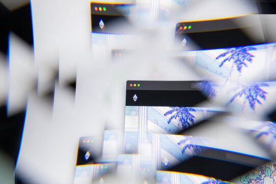 Milan, Italy - APRIL 10, 2021: Ethereum cryptocurrency coin logo on laptop screen seen through an optical prism. Illustrative editorial image from Ethereum cryptocurrency coin website.