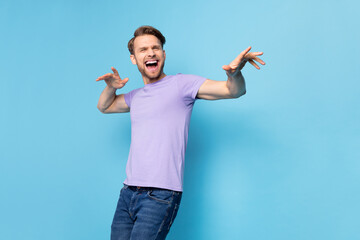 Portrait of glad satisfied person partying open mouth smile arms palms make moves isolated on blue...