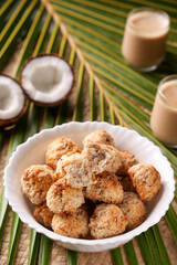Coconut cookies macaron , macaroon copra biscuit and Indian milk tea chai on a coconut palm leaf background closeup of tea and snacks Kerala India Sri Lanka