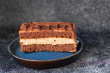 piece of chocolate cake with mousse cream sweet dessert vanilla cocoa cinnamon snack trend meal copy space food background rustic. top view