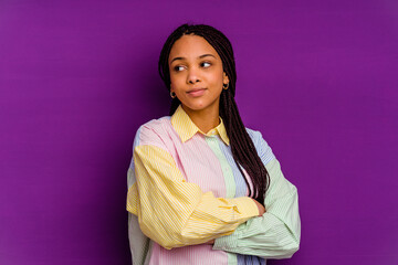 Young african american woman isolated on yellow background dreaming of achieving goals and purposes