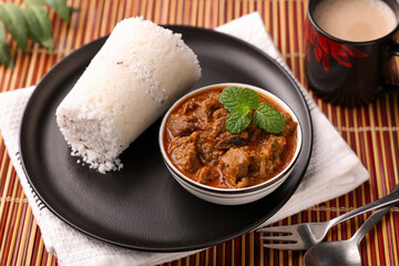 Beef curry , White rice Puttu, Pittu and tea south Indian breakfast meat curry mutton curry Kerala Tamil Nadu. steamed rice cake mutton roast Indian spices non vegetarian side dish India Sri Lanka 
