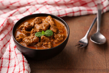 Beef curry Kerala style meat curry or mutton curry   south Indian style. Bowl of tasty mutton roast with Indian spices  non vegetarian side dish food India Sri Lanka . Lankan food