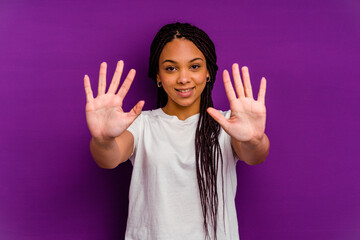 Young african american woman isolated on yellow background showing number ten with hands.