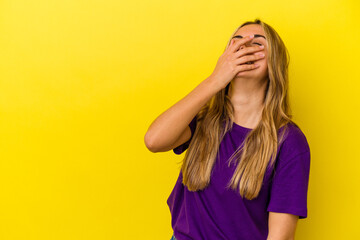 Fototapeta na wymiar Young blonde caucasian woman isolated on yellow background laughing happy, carefree, natural emotion.