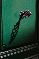 Green door with metal spiral handle