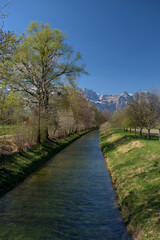 Small canal in the nature in Vaduz in Liechtenstein 4.4.2021