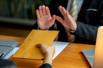 Businessman refusing money in the envelope offered by a man - anti , illegal and dishonest,bribery...