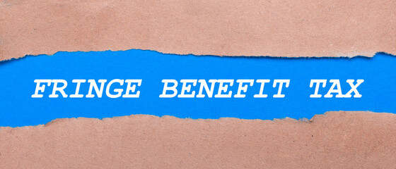 A strip of blue paper with the words FRINGE BENEFIT TAX between the brown paper. View from above