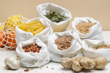 Food in bulk sacks. Zero waste and plastic free shopping concept. Sustainable lifestyle. Groceries in reusable textile bags on table.