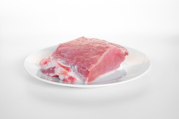 sliced raw pork meat isolated on white background ready for cooking. a piece of pork