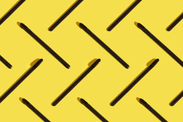 Black toothbrush pattern on the illuminating yellow background. Hard shadows. Trend color of the year 2021. 