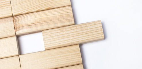On a light background, wooden blocks with a place to insert text. Close-up top view. Template