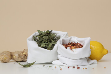 Natural tea and herbs in bulk sacks. Zero waste and plastic free shopping concept. Sustainable lifestyle. Groceries in reusable textile bags on table.