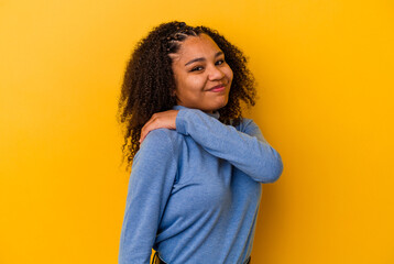 Young african american woman isolated on yellow background having a shoulder pain.