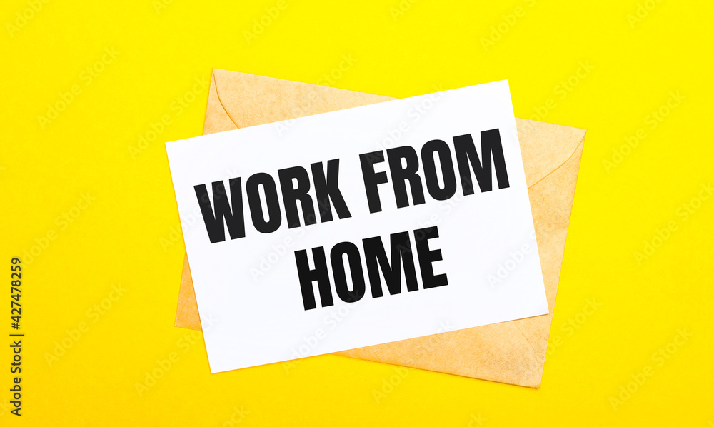 Poster on a yellow background, an envelope and a card with the text work from home. view from above