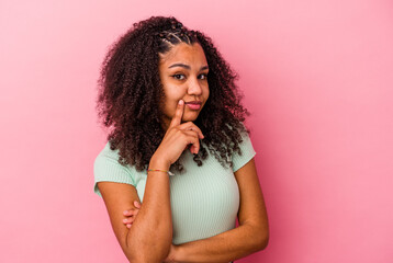 Young african american woman isolated on pink background unhappy looking in camera with sarcastic expression.