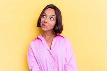 Fototapeta premium Young mixed race woman isolated on yellow background dreaming of achieving goals and purposes