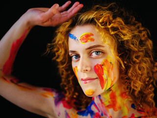 Beautiful girl with paint on her face and body