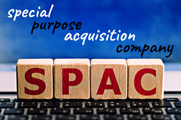 photo on spac (special purpose acquisition company) theme. wooden cubes with the abbreviation...