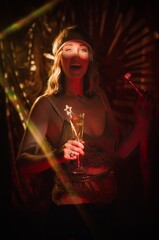 This photograph features a fashionable socialite woman dancing and smiling at a flapper party...