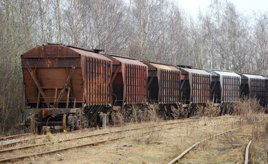 Fototapeta na wymiar Freight train at an old abandoned station