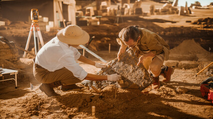 Archaeological Digging Site: Two Great Archeologists Work on Excavation Site, Carefully Cleaning,...