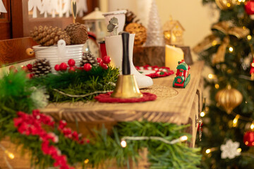 Christmas time. Close up and selective focus in a christmas train. Festive xmas tree decorated with warm lights on blurry background.