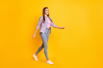 Fototapeta na wymiar Full length body size view of lovely skinny cheerful girl strolling walking isolated over bright yellow color background
