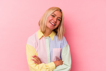 Young venezuelan woman isolated on pink background laughing and having fun.