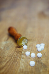 Vintage wax seal stamp lies on a wooden table. Golden spoon and pieces of wax