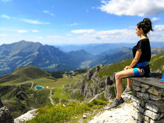 Young Woman looks at the stunning alps panorama - Piani di Bobbio