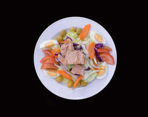 MIXED SALAD VIEW ON A BLACK BACKGROUND